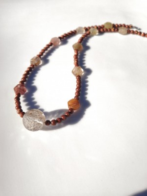 Handcrafted beaded necklace made of brown goldstone and rutilated quartz.