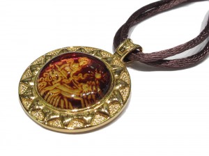 Natural back engraved amber pendant.