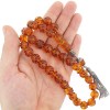 The amber beads are initially shaped and curved with spiral pattern details.