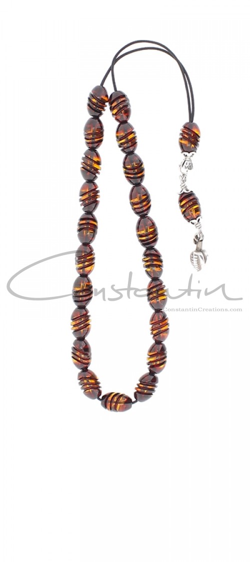 Greek Amber komboloi. Oval shaped beads with engraved details.